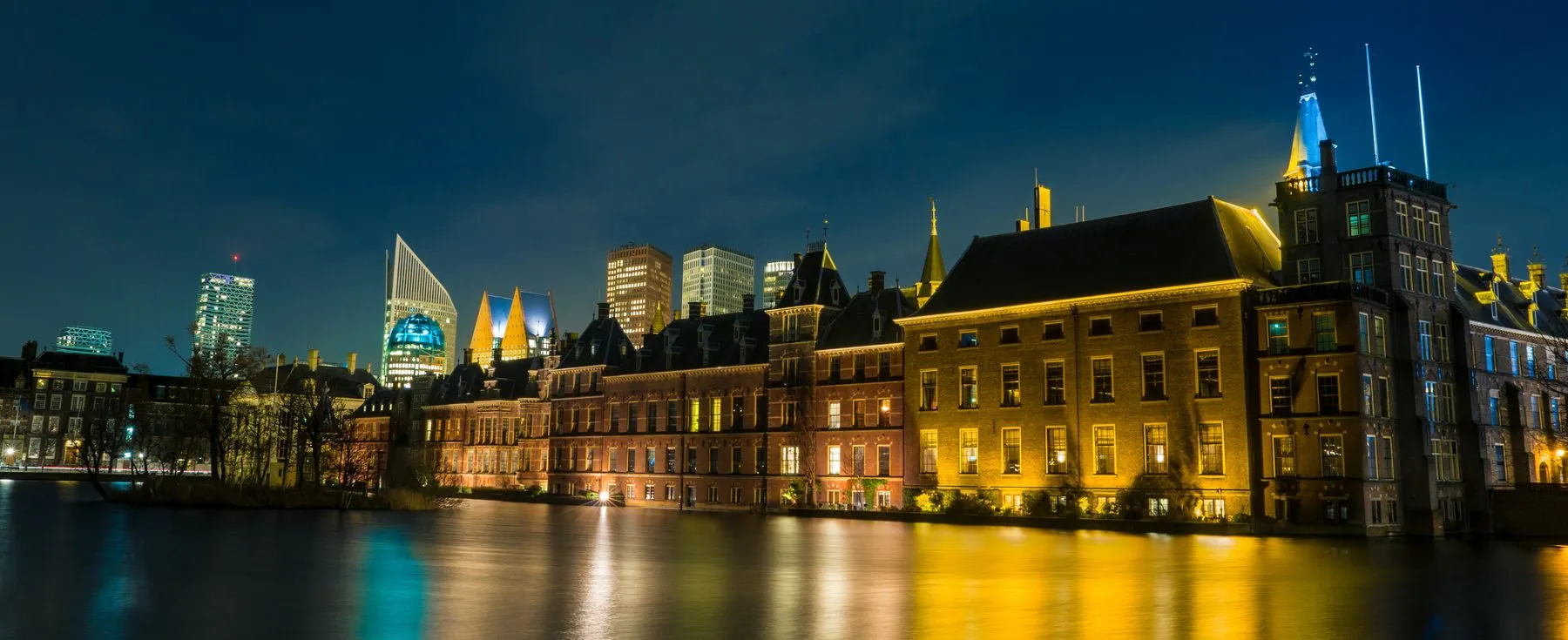 The Hague at night, with lit buildings reflected in the water